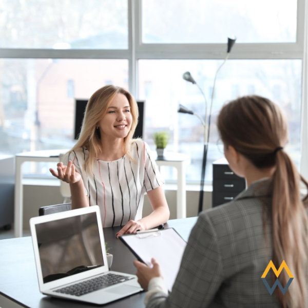 HR professional supporting an employee in a modern office environment.